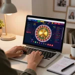 Engaged user playing roulette at 88bet casino on a laptop in a cozy home environment.