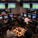 Excited patrons engaging in sports betting at a chic venue, showcasing modern da88 gaming technology.