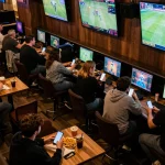 BCX88 fans engaged in live sports betting view with dynamic screens and enthusiastic atmosphere.